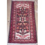 A Persian style small rug with stylised animal decoration 158 x 89cm
