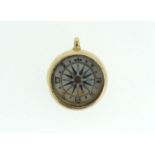 An 18 carat gold framed compass charm 0 8g a/f