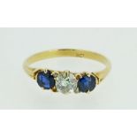 An 18 carat gold diamond and sapphire ring, size M 1/2