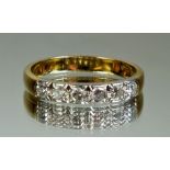 An 18 carat gold and platinum set six stone diamond ring, size S
