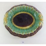 A Victorian Majolica bread plate decorated wheat