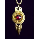 A Victorian gold pendant of circular Etruscan form set cabochon garnet with tassel drops and