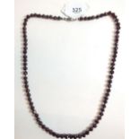 A faceted garnet necklace with silver clasp