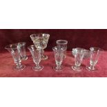 A selection of antique glassware including ale flutes and a large cut glass goblet