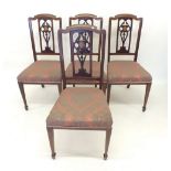A set of four Edwardian Art Nouveau dining chairs with inlay to slatted backs