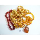 A quantity of amber beads and amber pendant