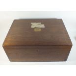An oak cutlery box with fitted interior and lift out trays