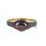 A Victorian hinged bangle set garnets (over 250) to lozenge design front and fully around the band -