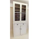 A tall Victorian painted pine cabinet with two glazed doors over two drawers and cupboard, width