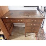 An Edwardian mahogany small style pedestal desk fitted with lined drawers and leather insert top