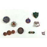 A box of badges including RMS Queen Elizabeth badge, London Transport silver pendant, Worcestershire