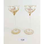 A pair of early 20th century continental tall stemmed liqueur glasses with enamelled floral