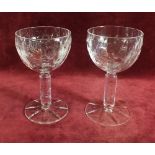 A pair of late 19th century 'Rock Cristal' wine glasses with daisy and foliage decoration to bowl,