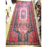 A large Iranian Hamadan runner with red ground 320 x 124cm
