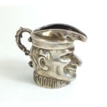A silver cream jug in the form of Mr Punch, import marks for 1901/1902- 79g - 5.5cm tall