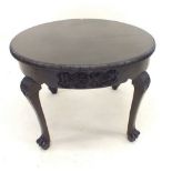 A mid 20th century circular dark wood coffee table