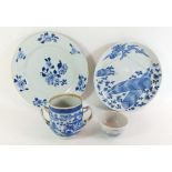 A Chinese blue and white tea bowl painted landscape, a two handled beakers (lacking lid) and two