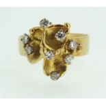 An 18 carat gold contemporary style ring set eight diamonds, size O, 5.6g, maker JA