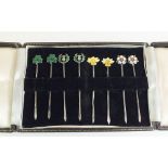 A set of eight silver and enamel Four Nations cocktail sticks with shamrock, thistle, daffodil and