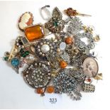 A box of various costume jewellery brooches