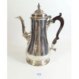 A George II silver dome top coffee pot with wooden handle, engraved crest and 'F', London 1754,