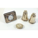 A group of silver items including pill box, pair of pepper pots and a silver clock