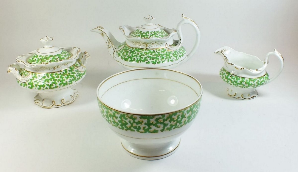 An early 19th century Ridgways green and gilt tea service comprising twelve teacups, twenty four