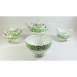 An early 19th century Ridgways green and gilt tea service comprising twelve teacups, twenty four