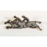 A white metal brooch in the form of two race horses set opals and chip diamonds, probably silver