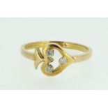 A 15ct gold ring with heart and arrow motif set three diamonds, size L 1/2, 2g