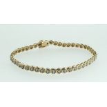 A 9 carat gold and diamond tennis bracelet, approx. 1/2 ct of diamonds in total