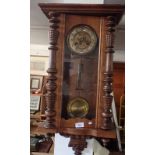 A 19th century mahogany cased wall clock with gilt metal dial embossed fuschia, key and pendulum