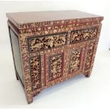 A Chinese gilt and red lacquer side cabinet with drawers over cupboard - 101cm wide