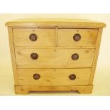 An Edwardian pine chest of two short and two long drawers 91 cm wide