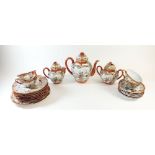 A Japanese Kutani eggshell part tea set decorated with figures within orange and gilt borders