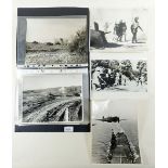 A folder of thirteen British official WWI original photographs including tanks, aircraft and troops