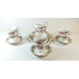 A Colclough tea service printed roses comprising jug, milk, six tea plates and a cake plate