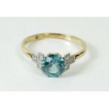 A gold ring set blue topaz on diamond set shoulders, size N, marks rubbed