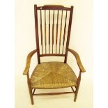 An Edwardian spindle back country chair with string seat