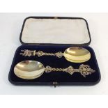 A pair of silver gilt presentation spoons with Elizabethan style handles in original velvet lined