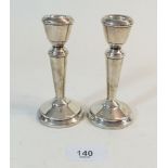 A pair of small silver weighted candlesticks, 11cm, Birmingham 1959