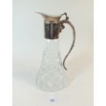 A cut glass claret decanter with silver plated mounts