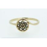 A 9 carat gold cluster ring set green stones, possibly Alexandrite - size R 1/2 to S.