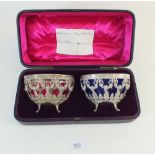 A pair of continental silver oval bon bon dishes (one glass liner missing) with floral swag