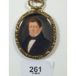 A 19th century watercolour on ivory of a gentleman, within yellow metal pendant frame and chain (the