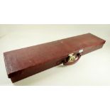 An early 20th century red leather rifle or shotgun case with velvet interior and brass fittings -