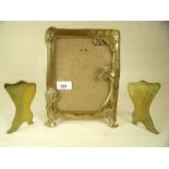 An Art Nouveau style brass picture frame 20cm tall, together with a pair of Victorian brass boot