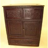 An antique carved oak cabinet - probably Victorian made from 17th century panels 82w x 96h x 52cm