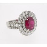 A fine 18 ct white gold ruby and diamond cluster ring, the central oval cut ruby 2.01cts within