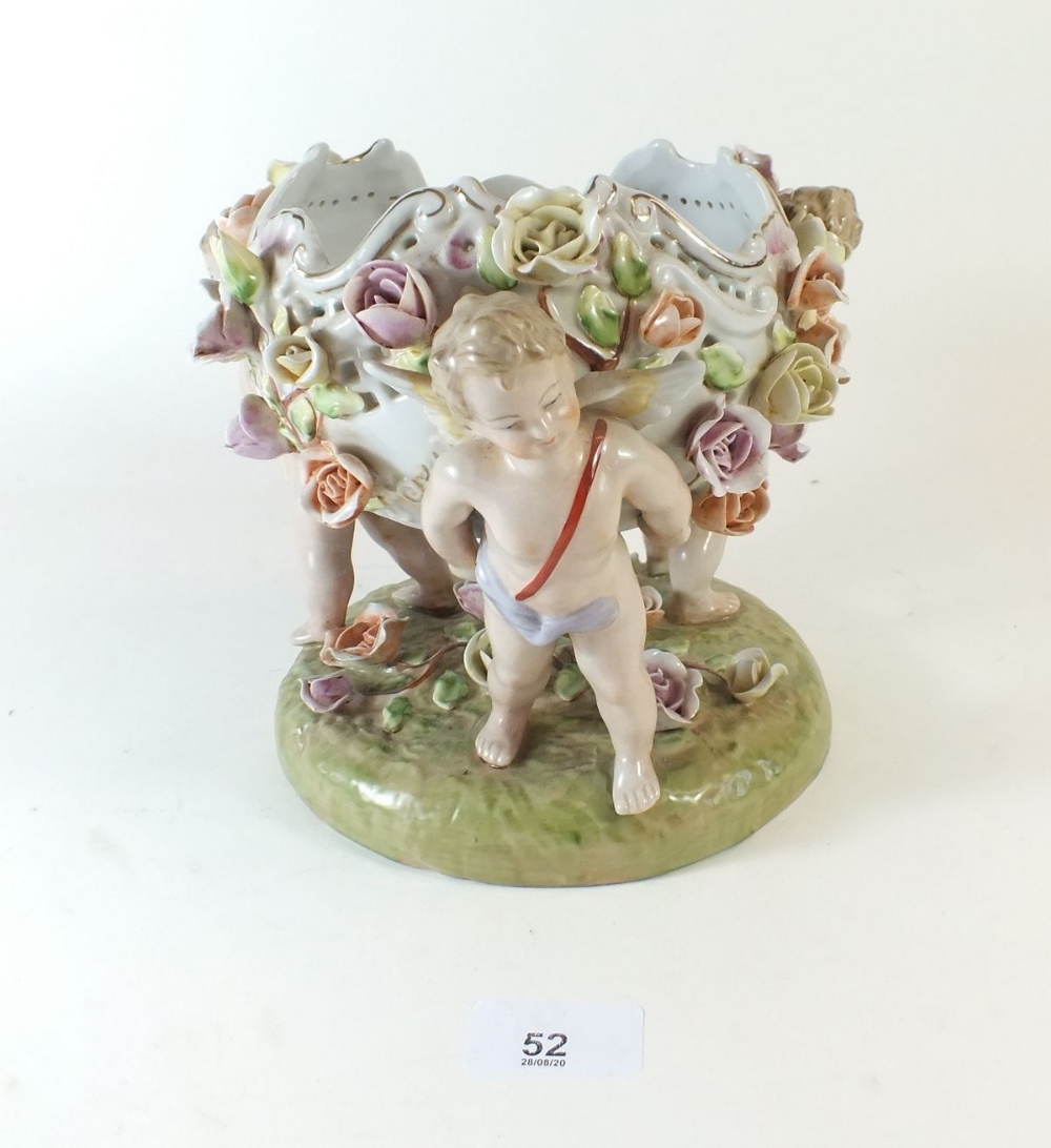 A Dresden German porcelain bowl decorated with cherubs and flowers 18cm tall